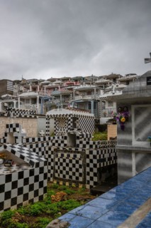 Famous cemetery, many mausoleums or large tombs decorated with tiles, often in black and white.