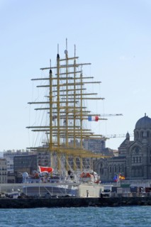 Marseille in the morning, Historic tall ship in the harbour in front of the city skyline under a