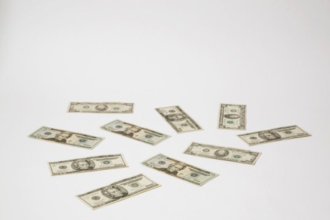 Close-up of US twenty dollar bills with portrait of Andrew Jackson on white background, Studio