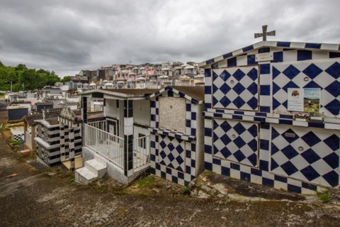 Famous cemetery, many mausoleums or large tombs decorated with tiles, often in black and white.