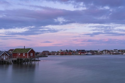 The village of Reine. Typical red wooden houses (rorbuer) on wooden stilts. At night at the time of