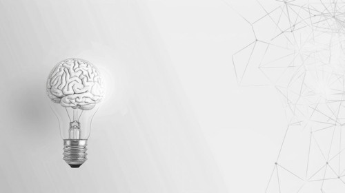 A light bulb with a brain as its filament set against a white background with geometric patterns,