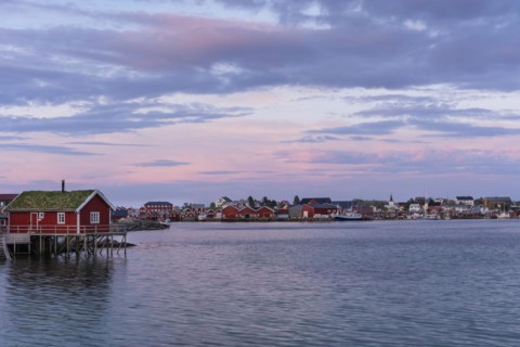 The village of Reine. Typical red wooden houses (rorbuer) on wooden stilts. At night at the time of