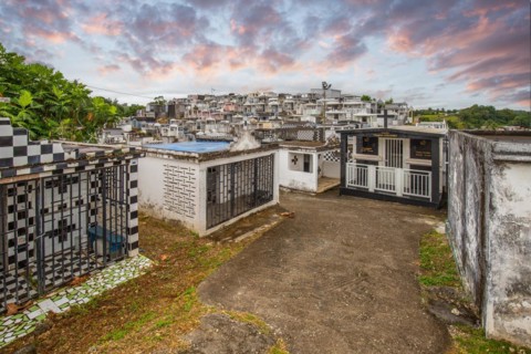 Famous cemetery, many mausoleums or large tombs decorated with tiles, often in black and white.