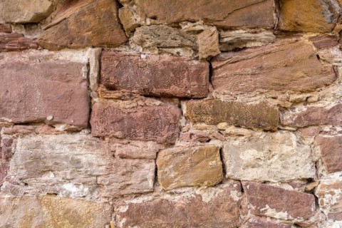 Wall made of sandstone, natural stone, quarry stone and mortar, background picture, old town,