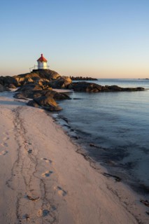 Seascape on the Lofoten Islands. The small lighthouse on the sandy beach of Eggum, sea and rocks.