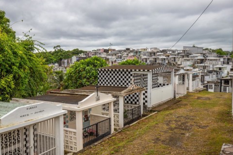 Famous cemetery, many mausoleums or large tombs decorated with tiles, often in black and white.