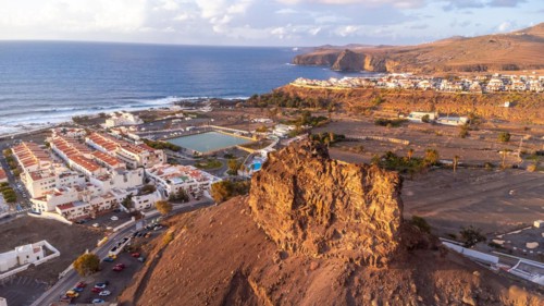 Aerial view of the town of Agaete and its Puerto de las Nieves at summer sunset in Gran Canaria.