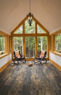 Reading room with tan and dark grey nuanced ceramic tile floor and two black leather rocking chairs