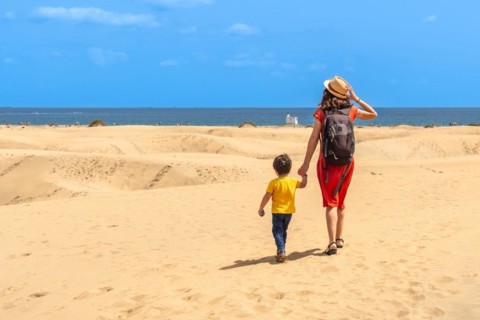 Mother and child on summer vacation in the dunes of Maspalomas, Gran Canaria, Canary Islands