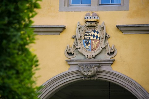 Mythical creature and ducal Wuerttemberg coat of arms above archway, stone figure, face, Winnental