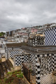 Famous cemetery, many mausoleums or large tombs decorated with tiles, often in black and white.