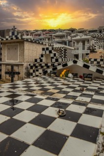 Famous cemetery, many mausoleums or large tombs decorated with tiles, often in black and white.
