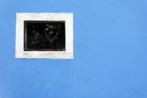 Colourful houses, Burano, Burano Island, Geometric window grille on a bright blue wall with a