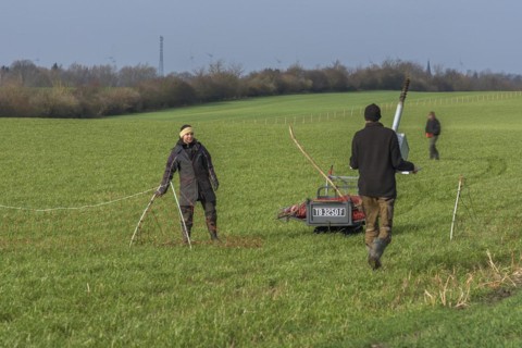 Shepherd and his daughter fence a new pasture with a solar panel for the electric fence,