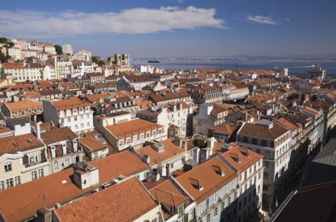 High angle view of buildings with traditional terracotta tiled rooftops in old Lisbon from Santa