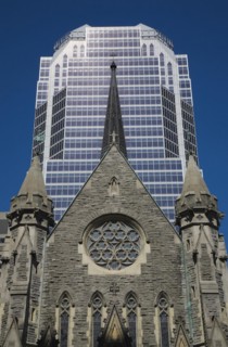 Old Christ Church Cathedral facade with rose window and modern architectural steel and blue tinted