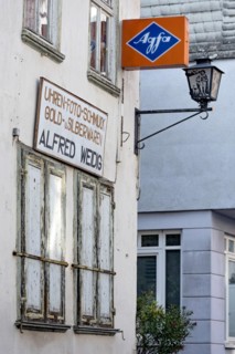 Cantilever sign, AGFA Film und Foto advertising sign, abandoned photo shop with watch shop,