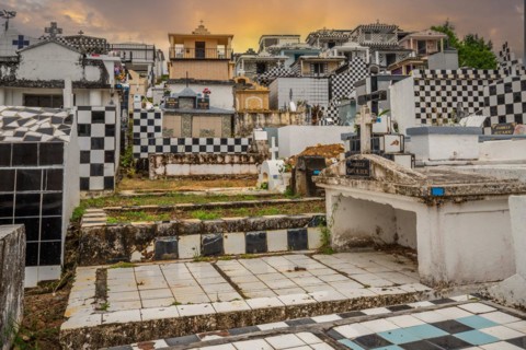 Famous cemetery, many mausoleums or large tombs decorated with tiles, often in black and white.