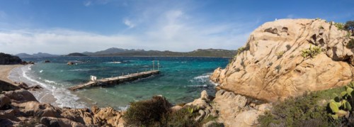 Rock formations, jetty leading into the sea, panoramic shot, Capriccioli beach, Costa Smeralda,