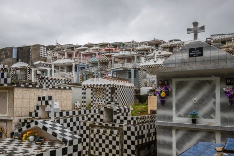 Famous cemetery, many mausoleums or large tombs decorated with tiles, often in black and white.