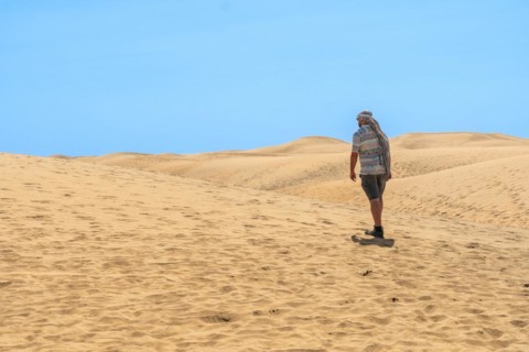 Portrait of male tourist in summer in the dunes of Maspalomas, Gran Canaria, Canary Islands