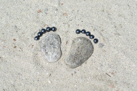 Footprints Made of Stones in the Sand