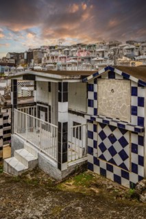Famous cemetery, many mausoleums or large tombs decorated with tiles, often in black and white.