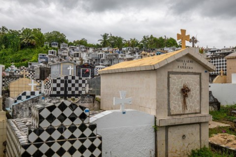 Famous cemetery, many mausoleums or large tombs decorated with tiles, often in black and white.