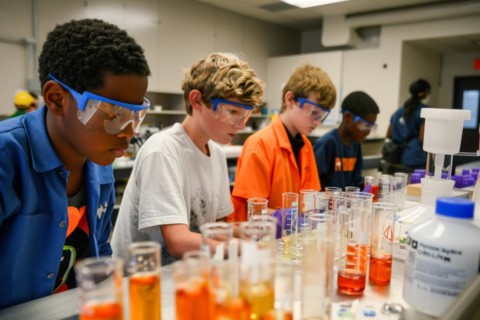 Pupils experimenting in a classroom with safety goggles, chemistry lessons, AI generated, AI