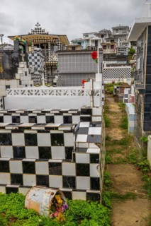 Famous cemetery, many mausoleums or large tombs decorated with tiles, often in black and white.