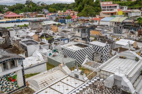 Famous cemetery, many mausoleums or large tombs decorated with tiles, often in black and white.