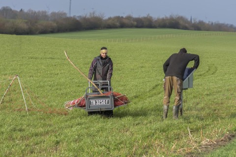 Shepherd and his daughter fence a new pasture with a solar panel for the electric fence,