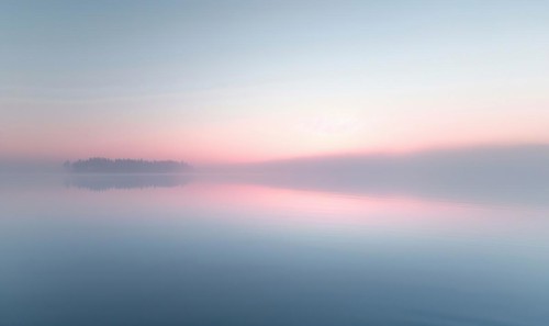 The soft pastel colors of dawn breaking over the horizon AI generated