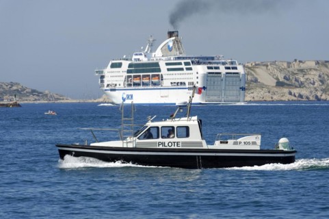 Marseille harbour, pilot boat on the sea off the coast, in the background a large ferry, Marseille,