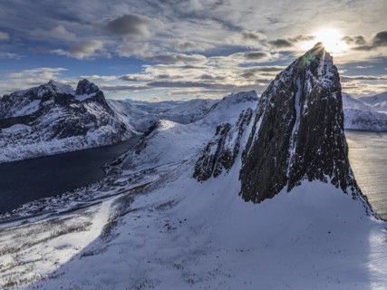 Aerial view of Bergen by the sea, fjord, sunbeams, winter, snow, Mount Segla, Senja, Troms, Norway,