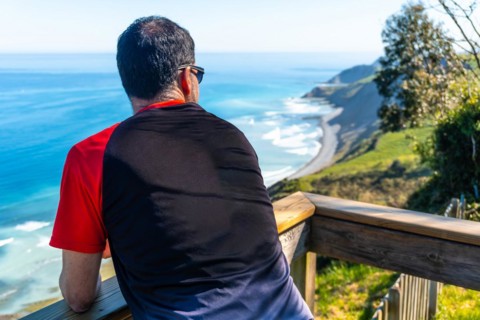 A tourist looking at the beautiful coastal landscape in the flysch of Zumaia, Gipuzkoa. Basque