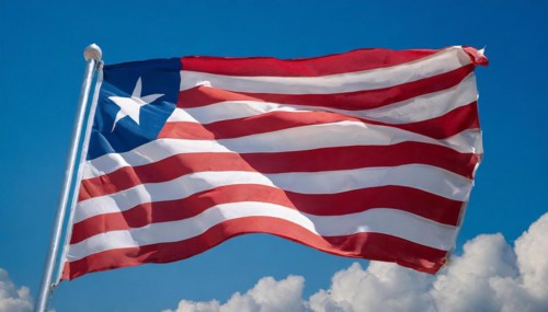 The flag of Liberia, fluttering in the wind, isolated, against the blue sky