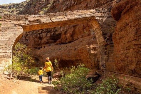 Family visiting the limestone canyon Barranco de las Vacas in Gran Canaria, Canary Islands