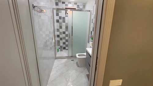 Interior of a modern bathroom with shower and toilet. Nobody inside
