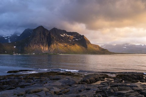 Landscape with sea and mountains on the Lofoten Islands, view across the fjord to the small town of