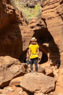 A woman with a hat in the limestone canyon Barranco de las Vacas on Gran Canaria, Canary Islands