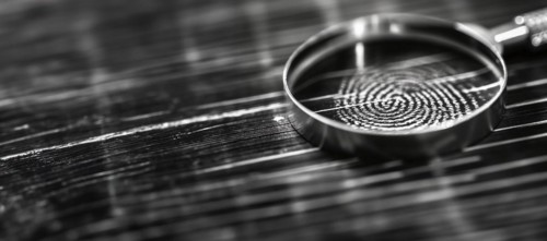 Banner of magnifying glass resting on a fingerprint on paper. generative AI, AI generated
