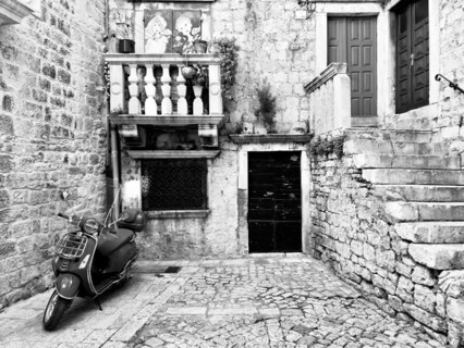 Black and white picture of a Vespa in an old-fashioned alley, Trogir, Dalmatia, Croatia, Europe