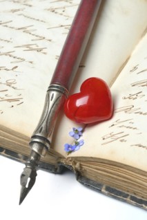Pen with pen holder and red heart on diary