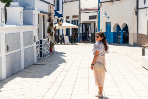 A woman walking through Puerto de Las Nieves in Agaete on Gran Canaria, Spain, Europe