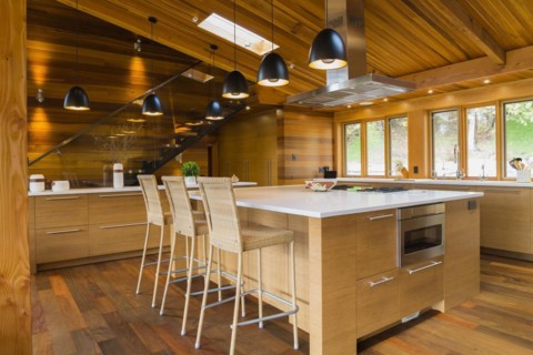 Bamboo wood island with white quartz countertops and high wicker chairs, buffet in kitchen with Ipe