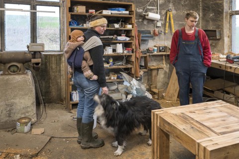 Family inspecting the table built by their son in the workshop, Mecklenburg-Vorpommern, Germany,