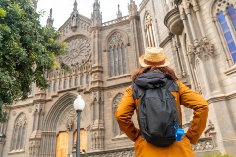 A tourist with a hat visiting the Church of San Juan Bautista, Arucas Cathedral, Gran Canaria,