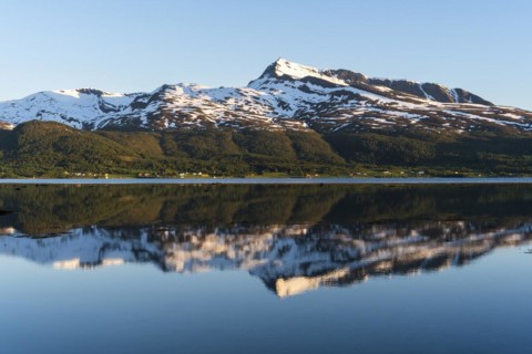 Landscape in Norway. The Balsfjord with a view of Mount Fugltinden. At night during the midnight